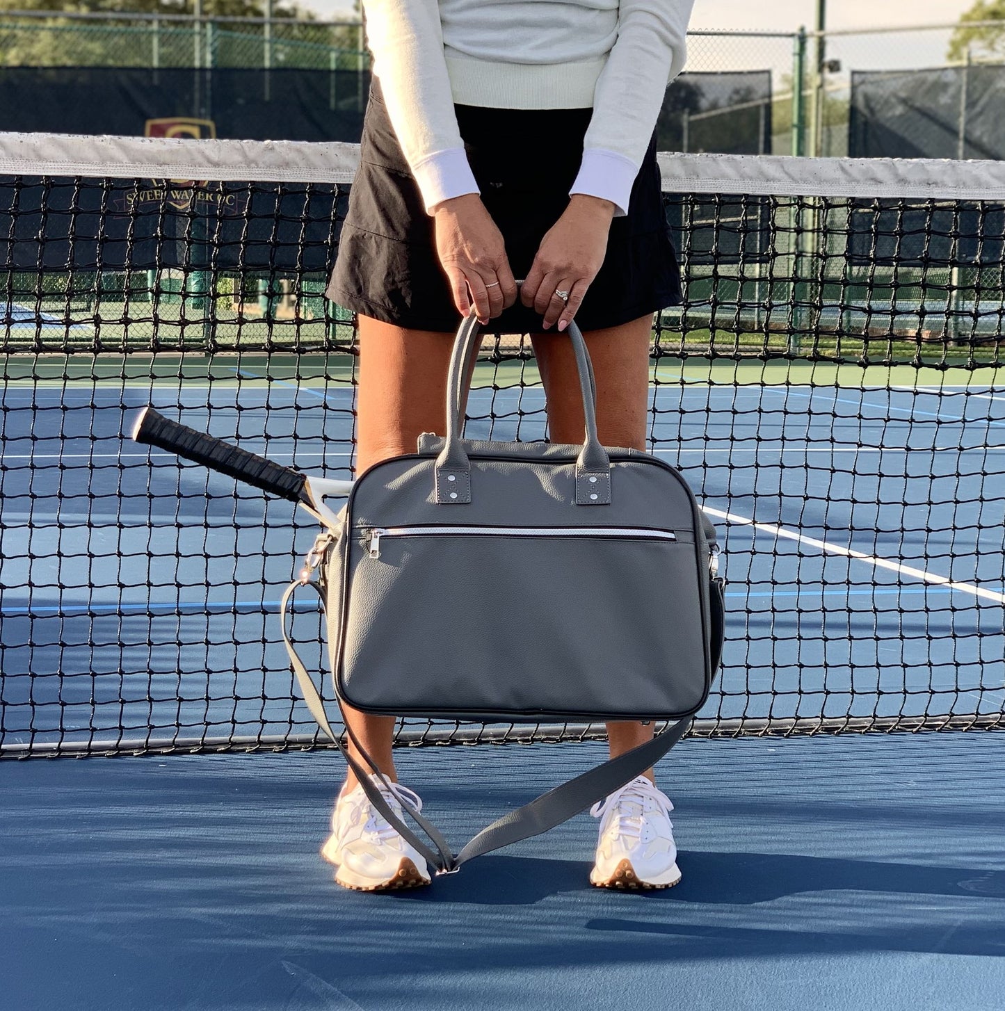 The LAVA medium tennis duffle bag is made of high quality pebble vegan leather;  with separate key and bottle holders. Specially designed racquet pockets can fit up to 2 tennis racquets