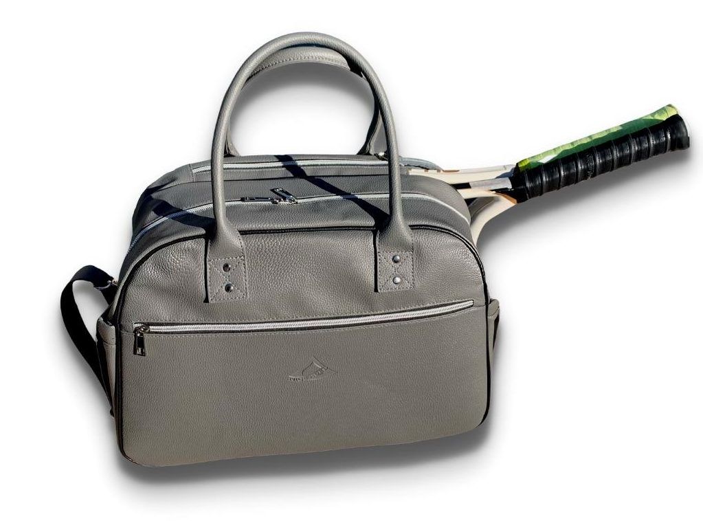 The LAVA medium tennis duffle bag is made of high quality pebble vegan leather;  with separate key and bottle holders. Specially designed racquet pockets can fit up to 2 tennis racquets